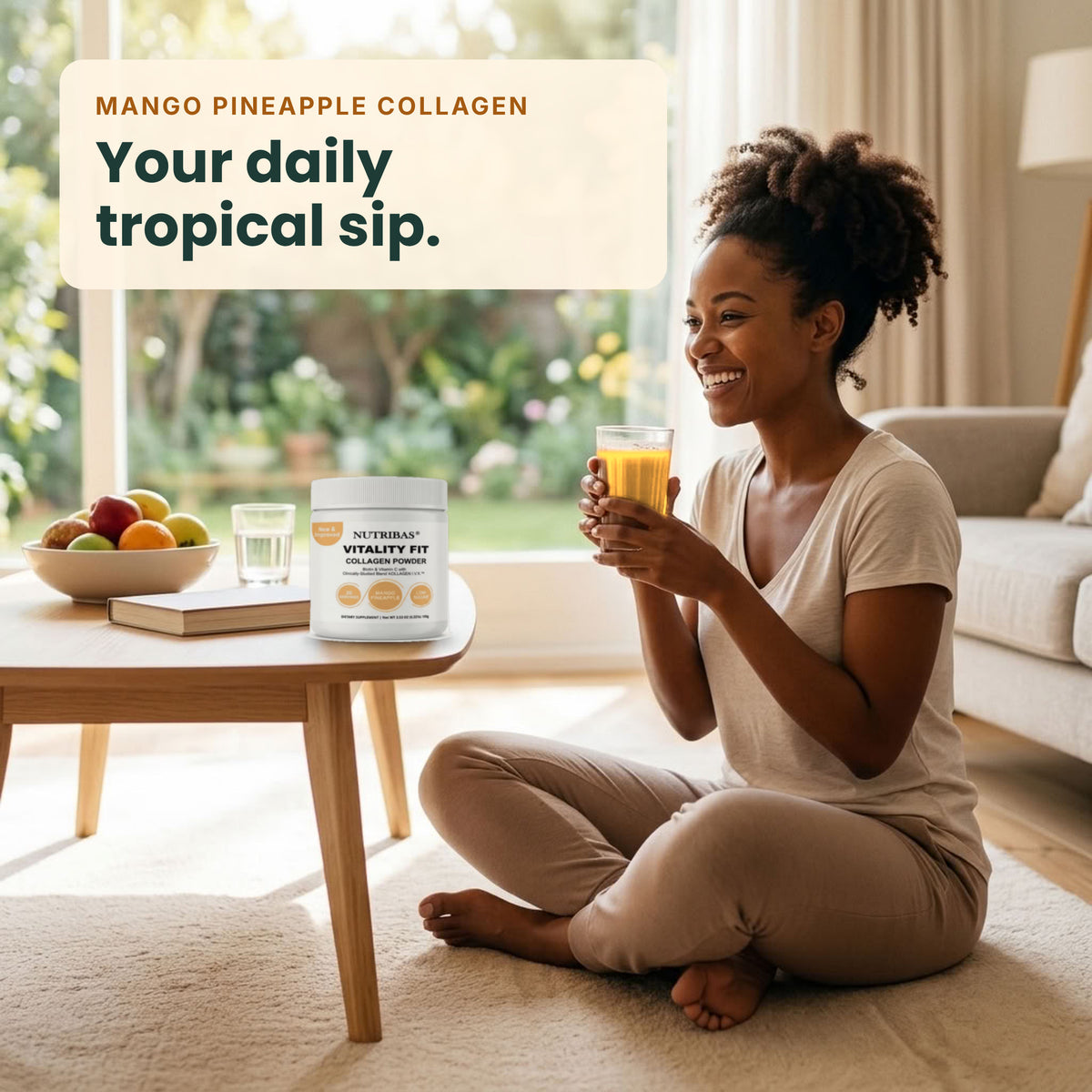 A woman sits cross-legged on a beige rug in a bright living room, holding a glass of orange drink. On the table beside her is a white tub of NutriLife365 Vitality Fizz powder labeled 'Mango Pineapple Collagen' with the text 'Your daily tropical sip.